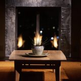 table in front of fireplace